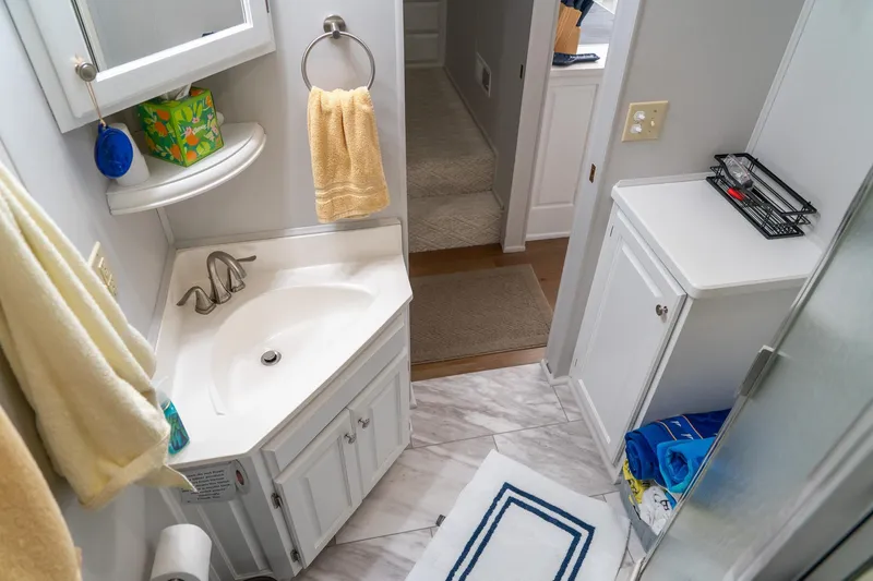 Slide: The Image of Bathroom interior of 1996 Lakeview 66 x 16 Widebody Houseboat, featuring sink and storage. - 50