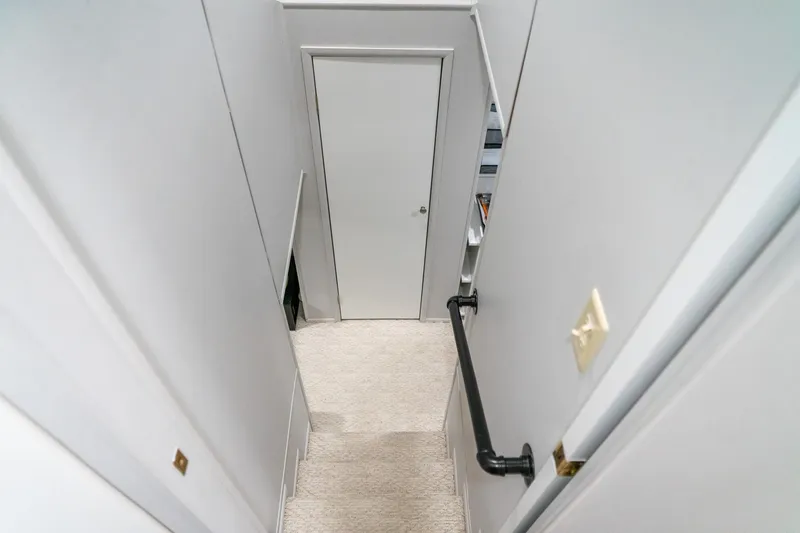 Slide: The Image of Staircase inside 1996 Lakeview 66 x 16 Widebody Houseboat, featuring white walls and carpet. - 54