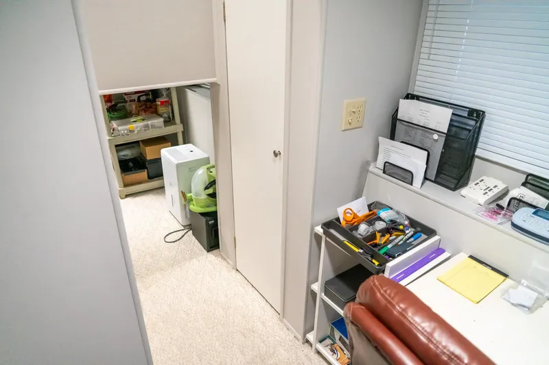 Slide: The Image of Office space inside 1996 Lakeview 66 x 16 Widebody Houseboat, featuring organized desk and storage. - 57