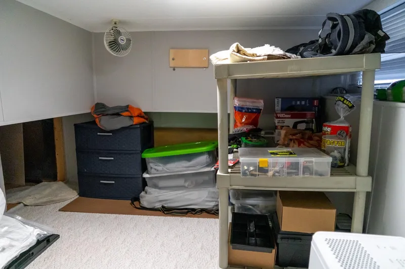 Slide: The Image of Storage area in a 1996 Lakeview 66 x 16 Widebody Houseboat with shelves and supplies. - 58