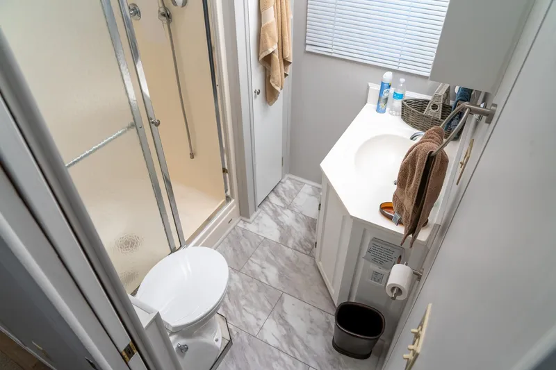 Slide: The Image of Compact bathroom in 1996 Lakeview 66 x 16 Widebody Houseboat with shower and vanity. - 59