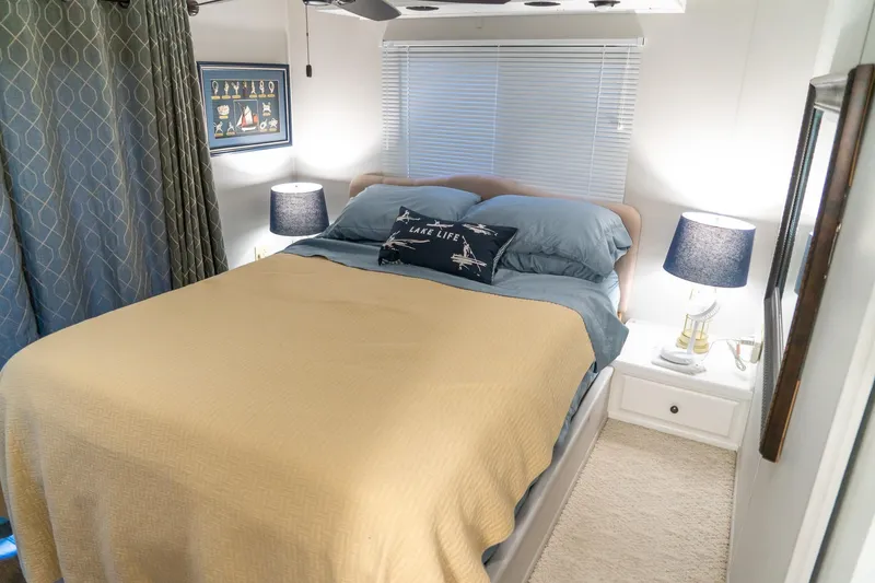 Slide: The Image of Cozy bedroom in 1996 Lakeview houseboat with nautical decor and soft lighting. - 62