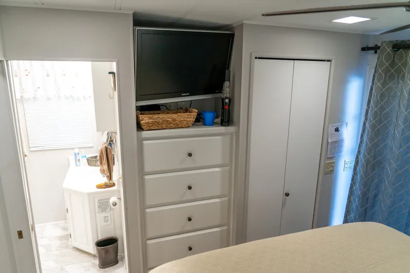 Slide: The Image of Interior of 1996 Lakeview 66 x 16 Widebody Houseboat with TV, dresser, and bathroom. - 63