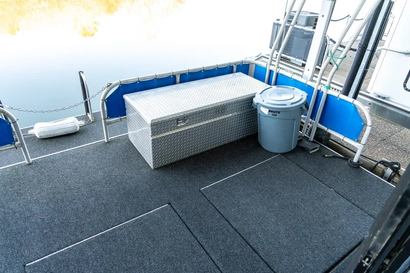 Slide: The Image of 1996 Lakeview 66 x 16 Widebody Houseboat deck with storage box and trash bin. - 69