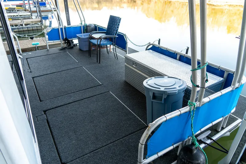 Slide: The Image of 1996 Lakeview 66 x 16 Widebody Houseboat deck with seating, storage, and water view. - 71