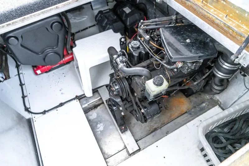 Slide: The Image of Engine compartment of a 1996 Lakeview 66 x 16 Widebody Houseboat, showing mechanical components. - 73