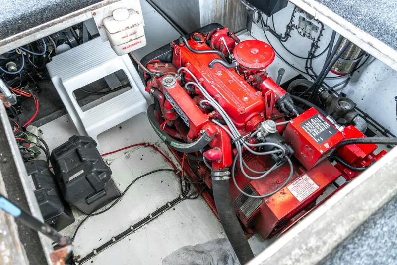 Slide: The Image of Engine compartment of a 1996 Lakeview 66 x 16 Widebody Houseboat, featuring a red engine. - 74