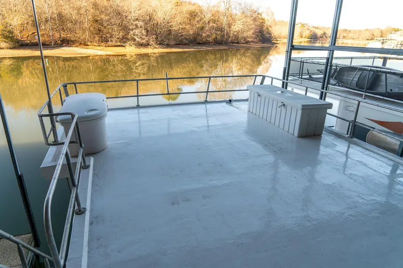 Slide: The Image of Spacious deck of 1996 Lakeview 66 x 16 Widebody Houseboat on serene lake. - 76