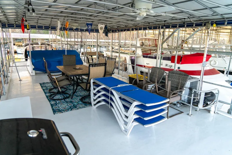 Slide: The Image of Spacious deck of 1996 Lakeview 66 x 16 Widebody Houseboat with seating and decor. - 79