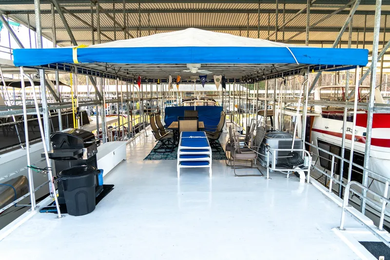 Slide: The Image of 1996 Lakeview 66 x 16 Widebody Houseboat with covered deck and outdoor seating area. - 80