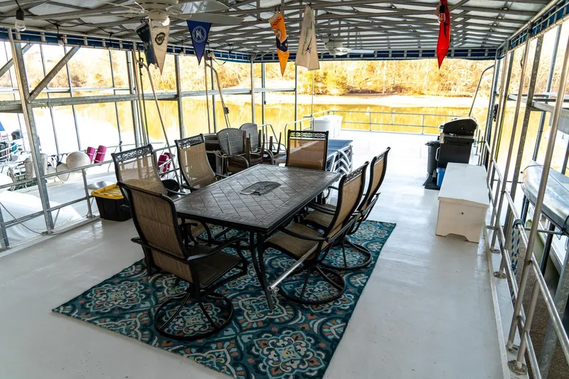 Slide: The Image of Spacious deck of 1996 Lakeview houseboat with dining area and scenic lake view. - 81