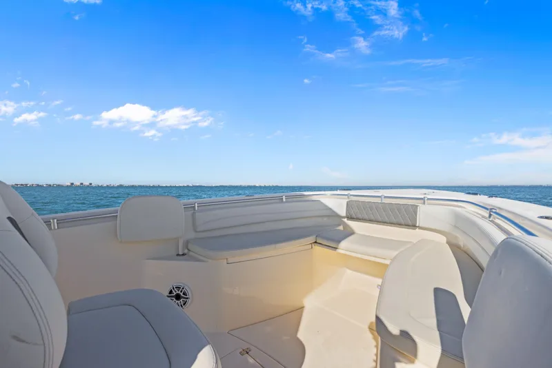 Slide: The Image of 2023 Cobia 301 Center Console boat interior with ocean view and clear blue sky. - 12