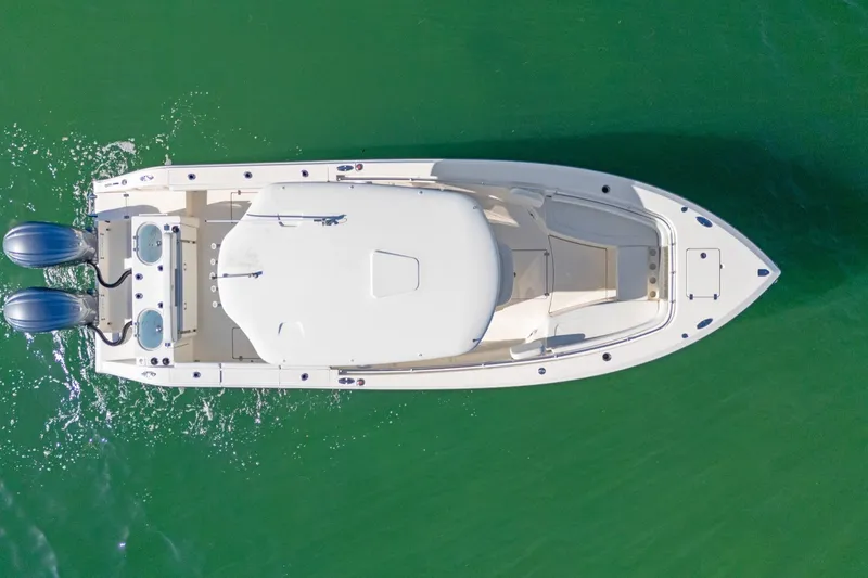 Slide: The Image of Overhead view of 2023 Cobia 301 Center Console boat on green water. - 8