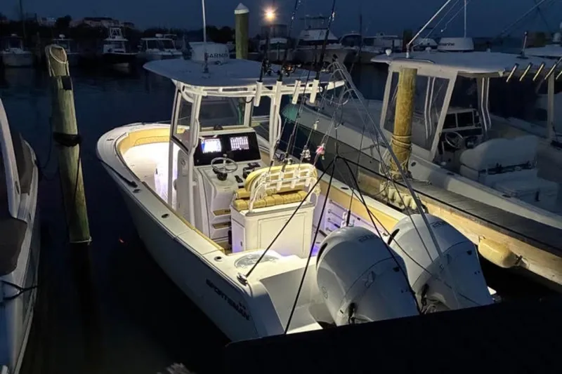 The Image of 2021 Sportsman Open 252 Center Console boat docked in a marina. - 0