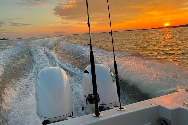 Slide: The Image of 2021 Sportsman Open 252 Center Console cruising at sunset with dual engines. - 11