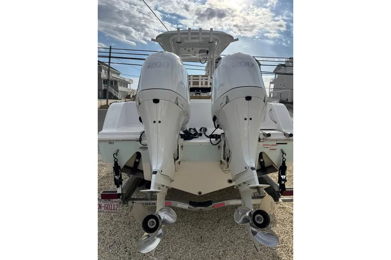 Slide: The Image of 2021 Sportsman Open 252 Center Console with dual outboard engines, rear view. - 13