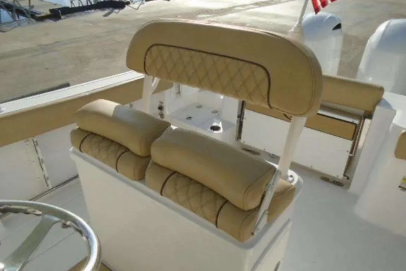 Slide: The Image of 2021 Sportsman Open 252 Center Console boat with tan cushioned seating. - 7