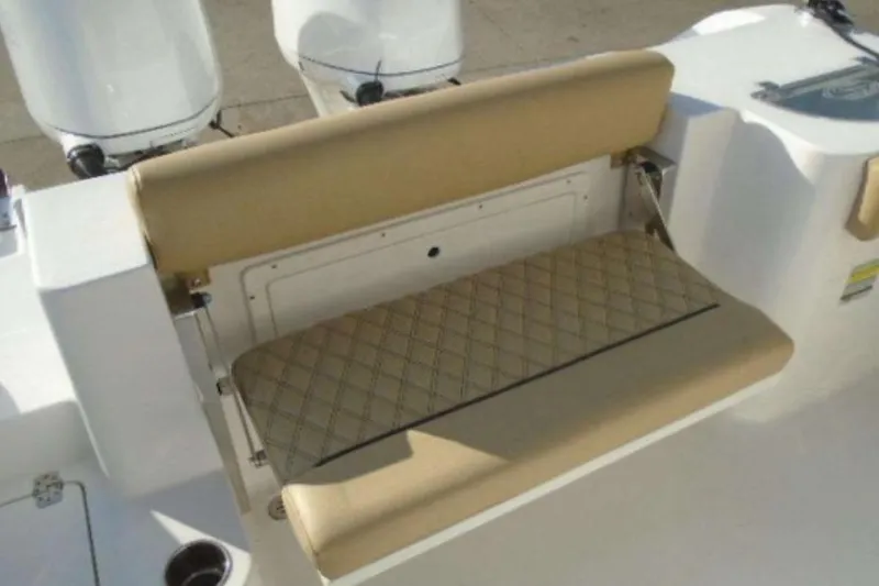 Slide: The Image of 2021 Sportsman Open 252 Center Console boat with tan cushioned seating. - 8
