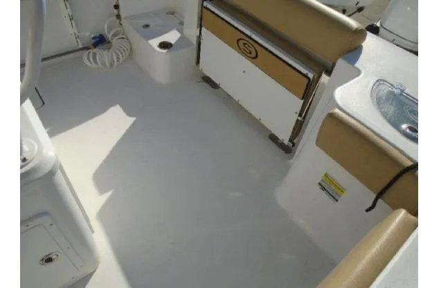 Slide: The Image of 2021 Sportsman Open 252 Center Console boat interior with seating and storage. - 9