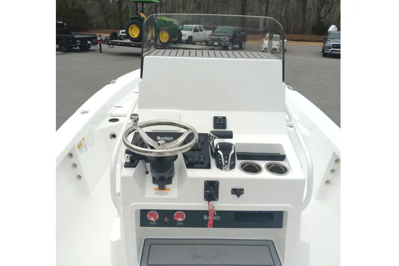 Slide: The Image of 2026 BlackJack 256 Bay boat console with steering wheel and controls. - 12