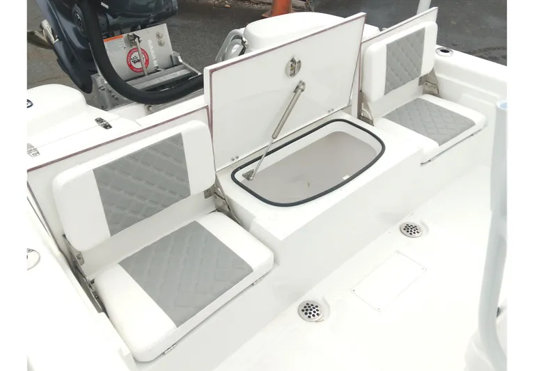 Slide: The Image of 2026 BlackJack 256 Bay boat interior with cushioned seats and storage compartment. - 15