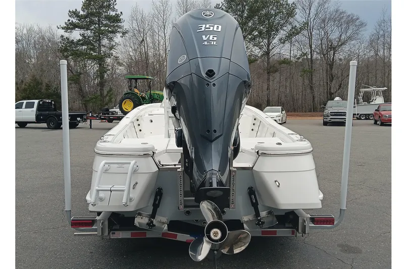 Slide: The Image of 2026 BlackJack 256 Bay boat with powerful 350 V6 engine, parked outdoors. - 3