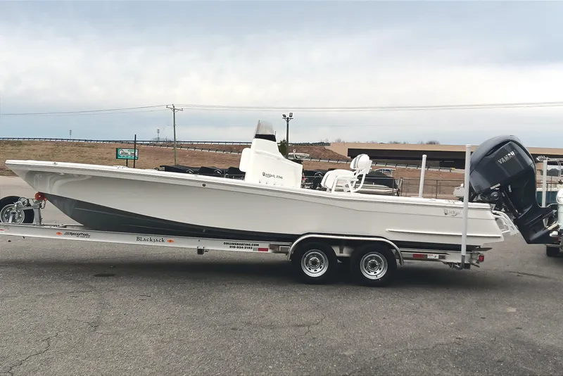Slide: The Image of 2026 BlackJack 256 Bay boat on trailer, featuring sleek design and Yamaha outboard motor. - 5