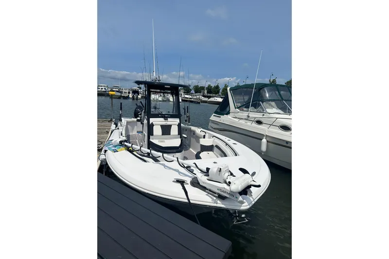 Slide: The Image of 2024 Tidewater 272 CC Adventure boat docked at marina, featuring Garmin equipment. - 3