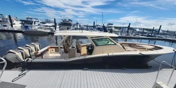 The Image of 2021 Scout LXF boat docked at marina with multiple outboard engines. - 0