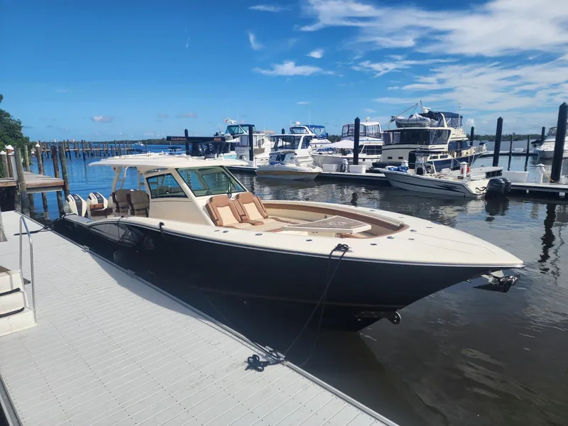 Slide: The Image of Luxury 2021 Scout LXF boat docked at marina under clear blue sky. - 1