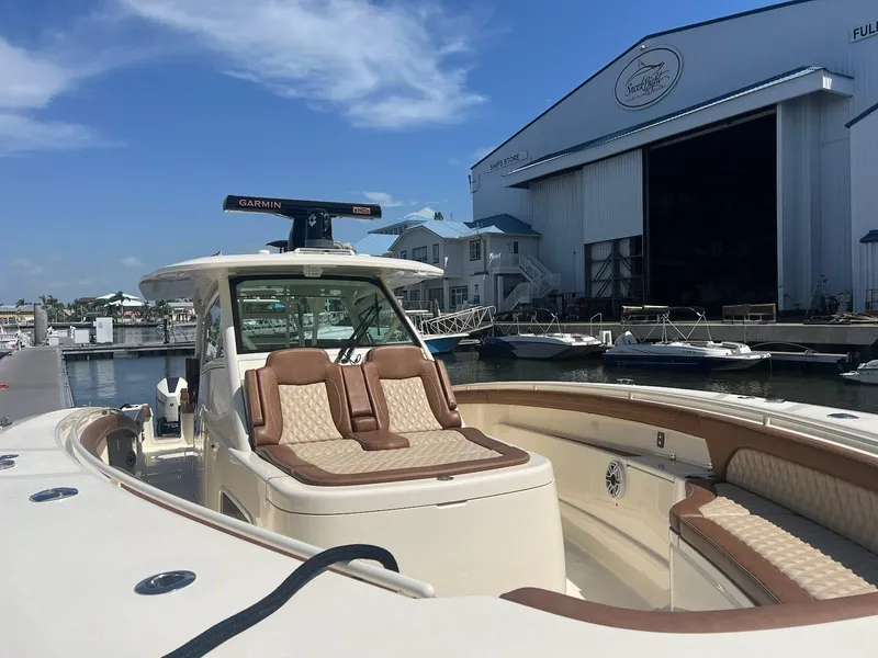 Slide: The Image of 2021 Scout LXF boat docked at marina, featuring luxurious seating and modern design. - 11