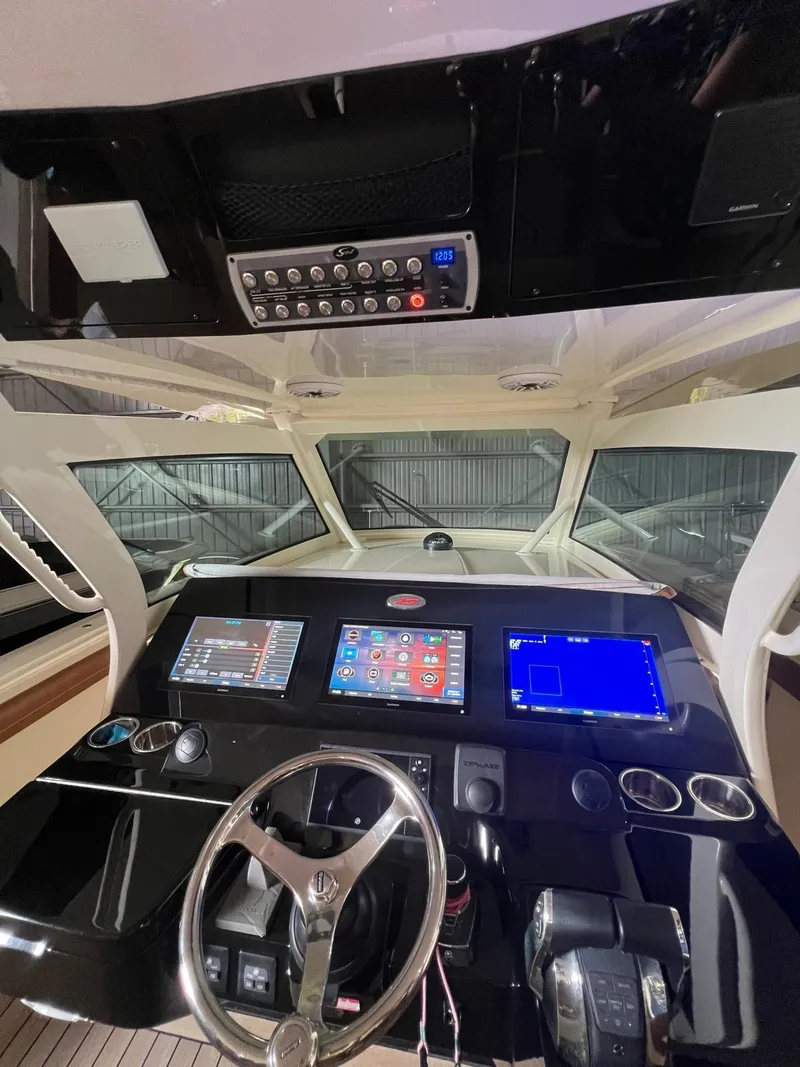 Slide: The Image of 2021 Scout LXF boat dashboard with advanced navigation and control systems. - 15