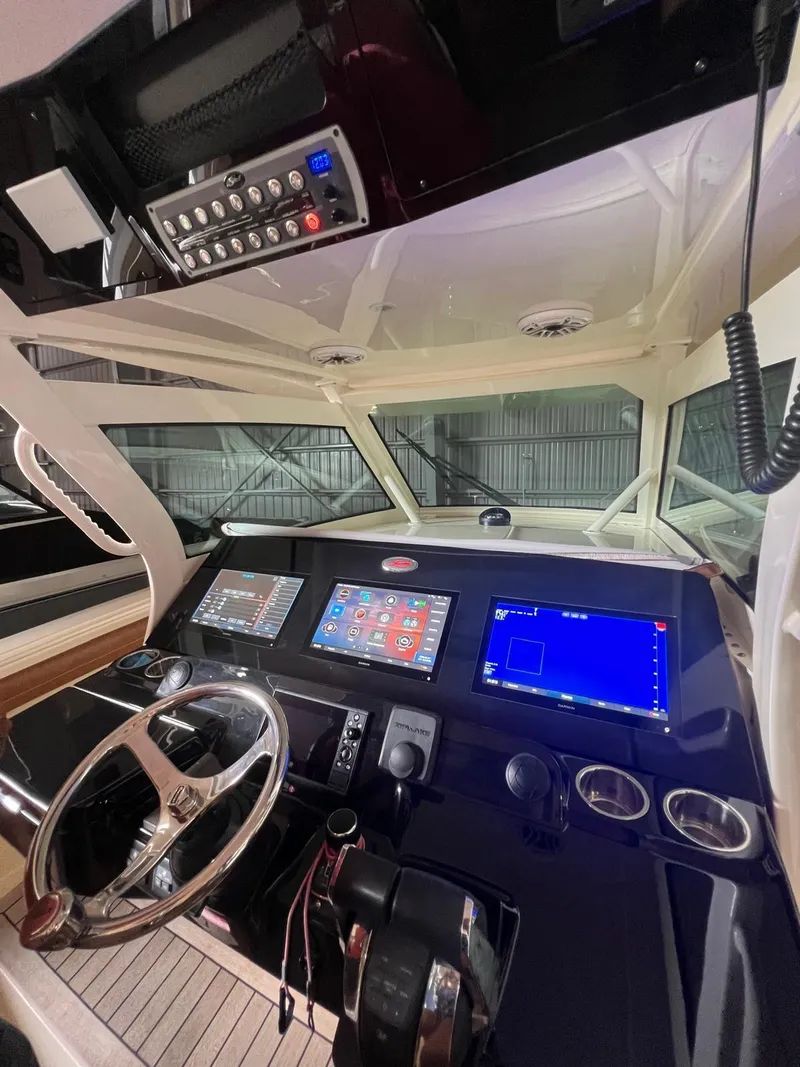 Slide: The Image of 2021 Scout LXF boat dashboard with advanced navigation and control systems. - 16