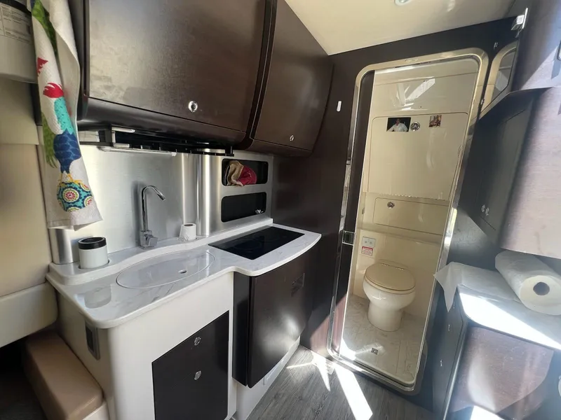 Slide: The Image of 2021 Scout LXF interior with compact kitchen and bathroom, featuring modern amenities and sleek design. - 18