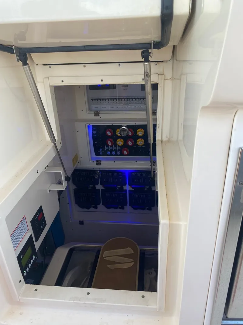 Slide: The Image of 2021 Scout LXF electrical panel with open hatch, showcasing control switches and wiring. - 19