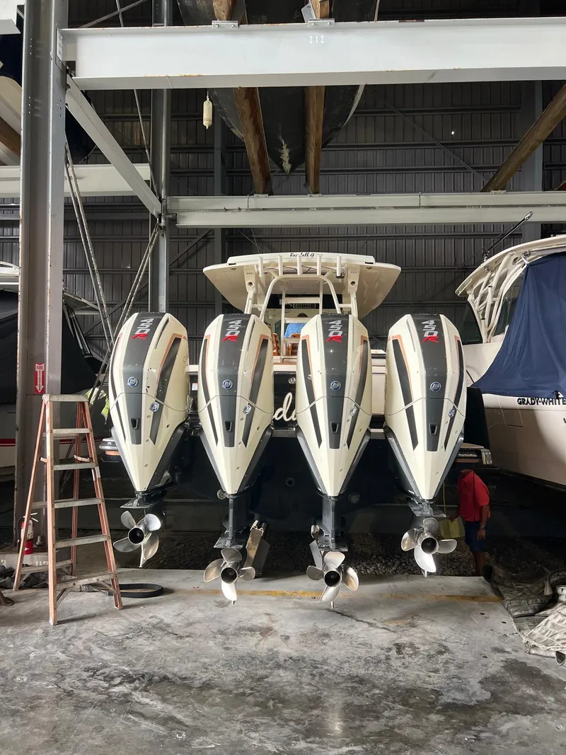 Slide: The Image of 2021 Scout LXF boat with four powerful outboard engines in storage. - 8