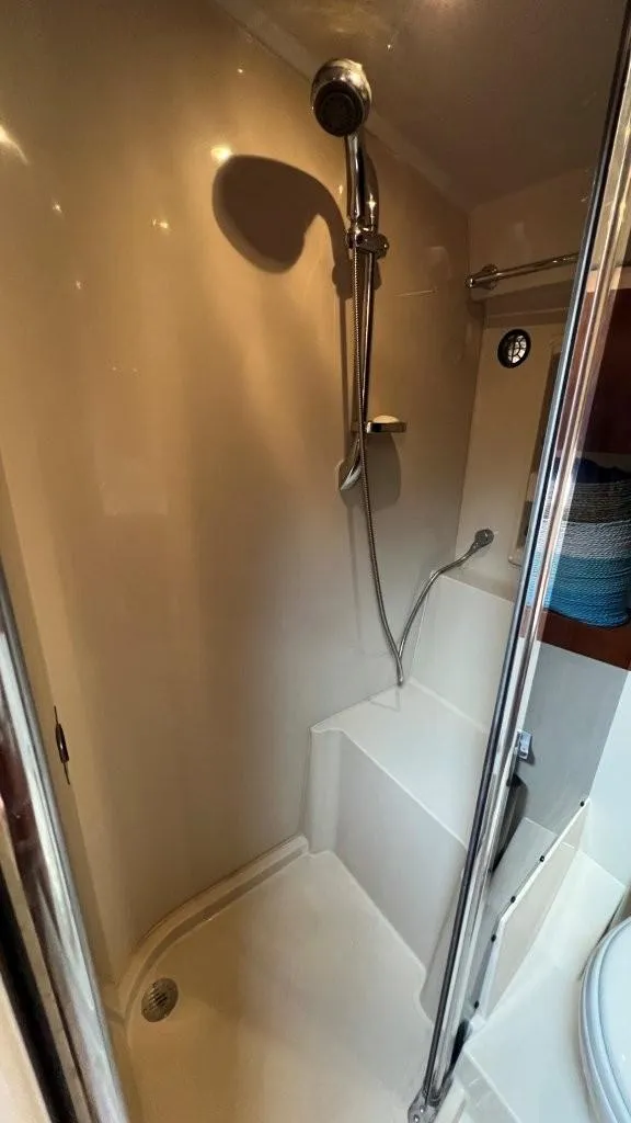 Slide: The Image of 2008 Cruisers 420 Express yacht shower with modern fixtures and seating area. - 17