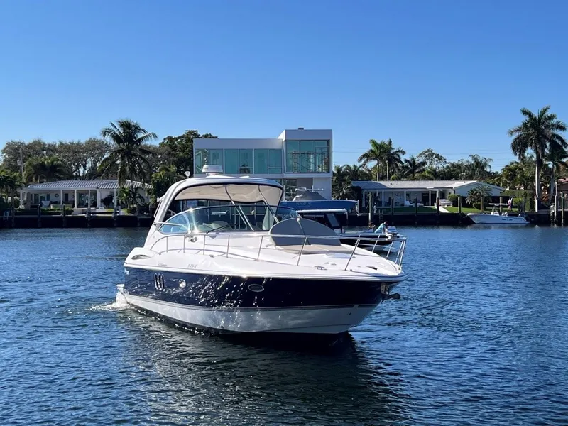 Slide: The Image of 2008 Cruisers 420 Express yacht on water, with waterfront homes and palm trees in the background. - 1