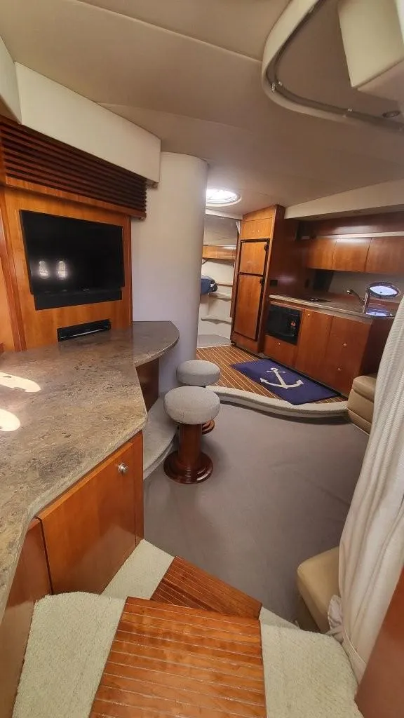 Slide: The Image of 2008 Cruisers 420 Express yacht interior with modern kitchen, seating, and entertainment area. - 10