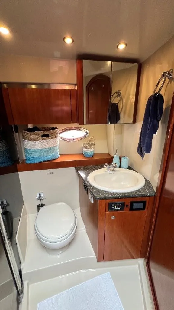 Slide: The Image of 2008 Cruisers 420 Express bathroom with sink, toilet, and wooden cabinetry. - 16