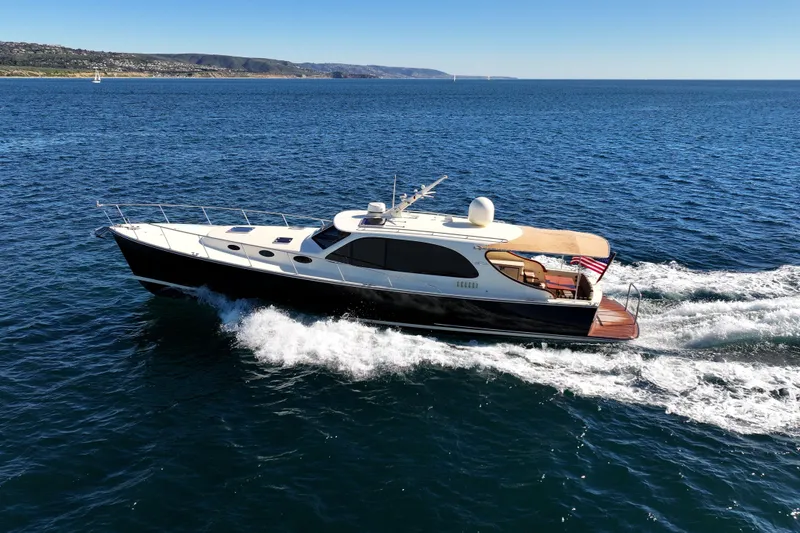 Slide: The Image of 2015 Palm Beach Motor Yachts PB45 cruising on open water under clear skies. - 20