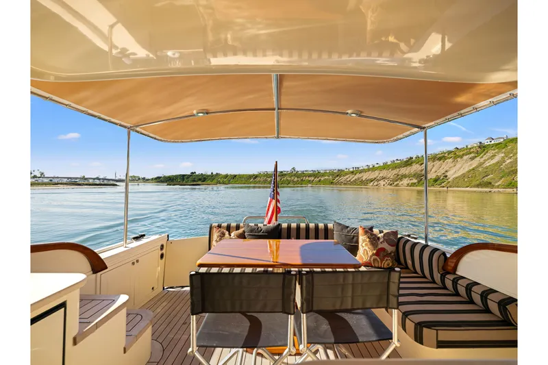 Slide: The Image of 2015 Palm Beach Motor Yachts PB45 interior with elegant seating and scenic water view. - 24