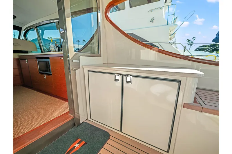 Slide: The Image of Interior of 2015 Palm Beach Motor Yachts PB45, featuring elegant cabinetry and modern design. - 29