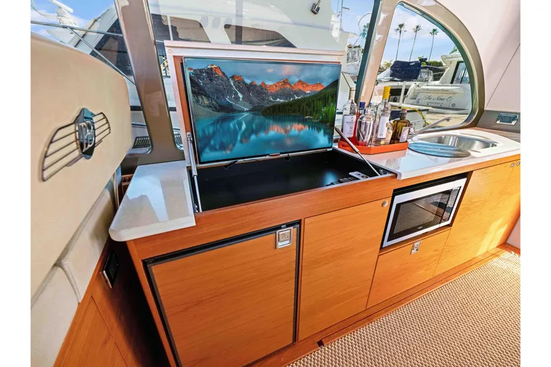 Slide: The Image of Luxurious interior of 2015 Palm Beach Motor Yachts PB45 with TV, sink, and microwave. - 37