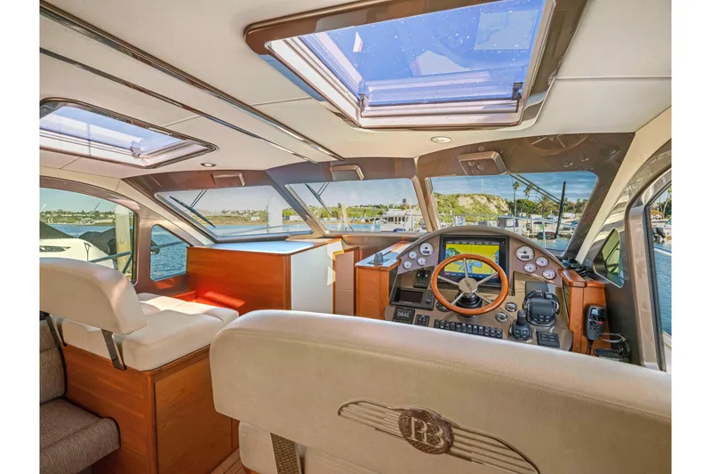 Slide: The Image of Interior of 2015 Palm Beach Motor Yachts PB45, featuring helm and luxurious seating. - 42