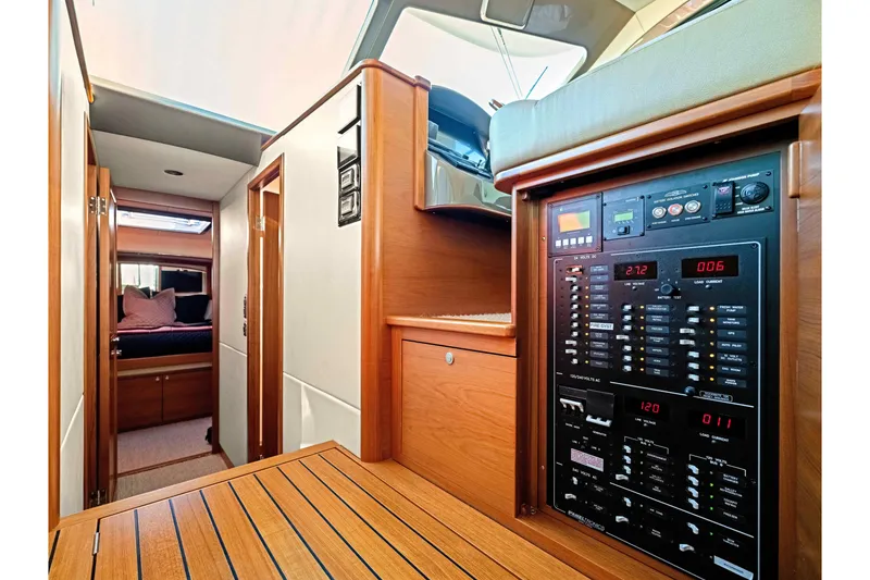 Slide: The Image of Interior of 2015 Palm Beach Motor Yachts PB45, featuring control panel and cabin view. - 46