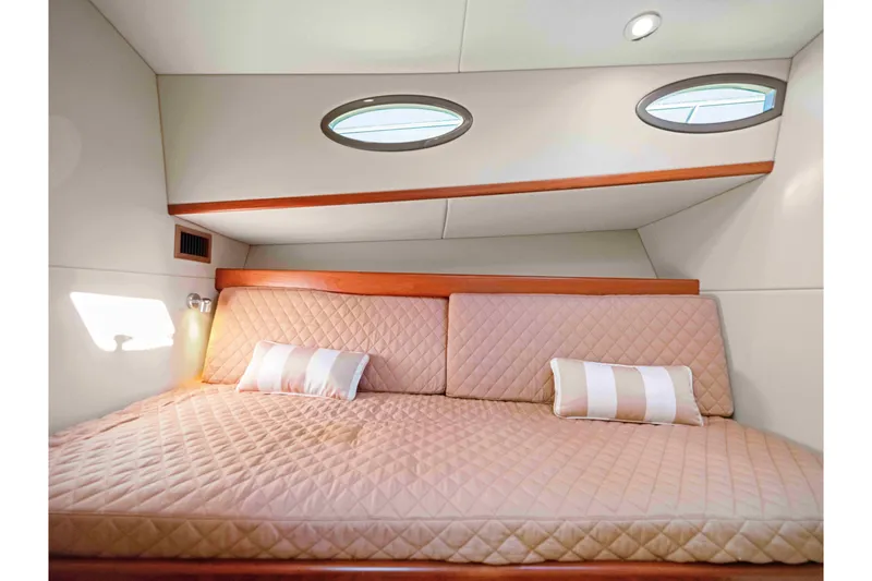 Slide: The Image of Luxurious cabin interior of 2015 Palm Beach Motor Yachts PB45 with quilted bedding. - 49