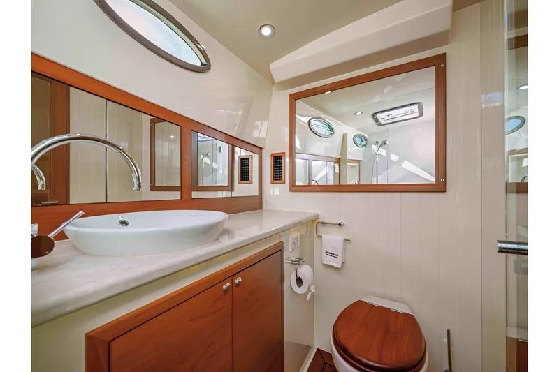 Slide: The Image of Luxurious bathroom interior of 2015 Palm Beach Motor Yachts PB45, featuring elegant wood accents. - 52
