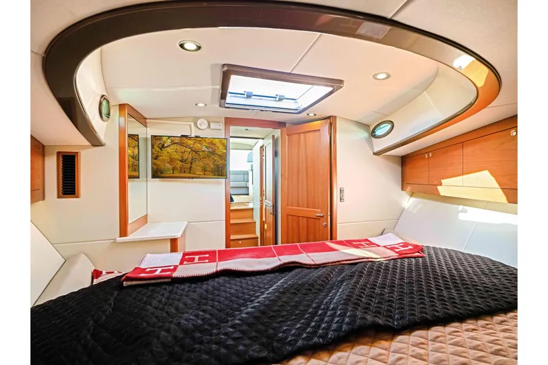 Slide: The Image of Luxurious interior of 2015 Palm Beach Motor Yachts PB45, featuring elegant wood finishes and skylight. - 56