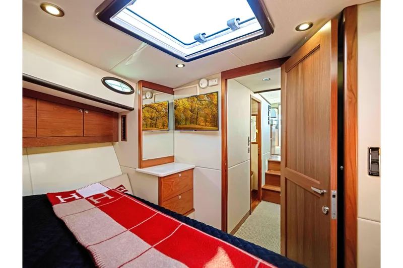 Slide: The Image of Luxurious 2015 Palm Beach Motor Yachts PB45 interior cabin with wood accents and skylight. - 57